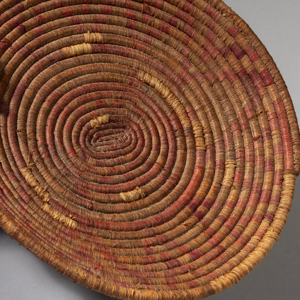 A WOVEN FIBRE BASKET WITH RED DESIGN FROM TUTSI TRIBE RWANDA( No 2177)