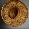 A VINTAGE LARGE WOVEN SUN HAT WITH DECORATIVE FLOURISH, FROM INDONESIA