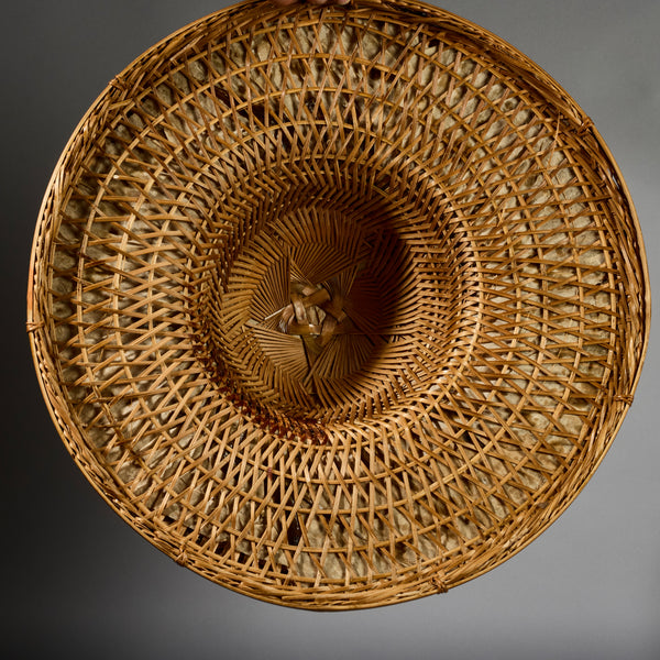 A VINTAGE LARGE WOVEN SUN HAT WITH DECORATIVE FLOURISH, FROM INDONESIA