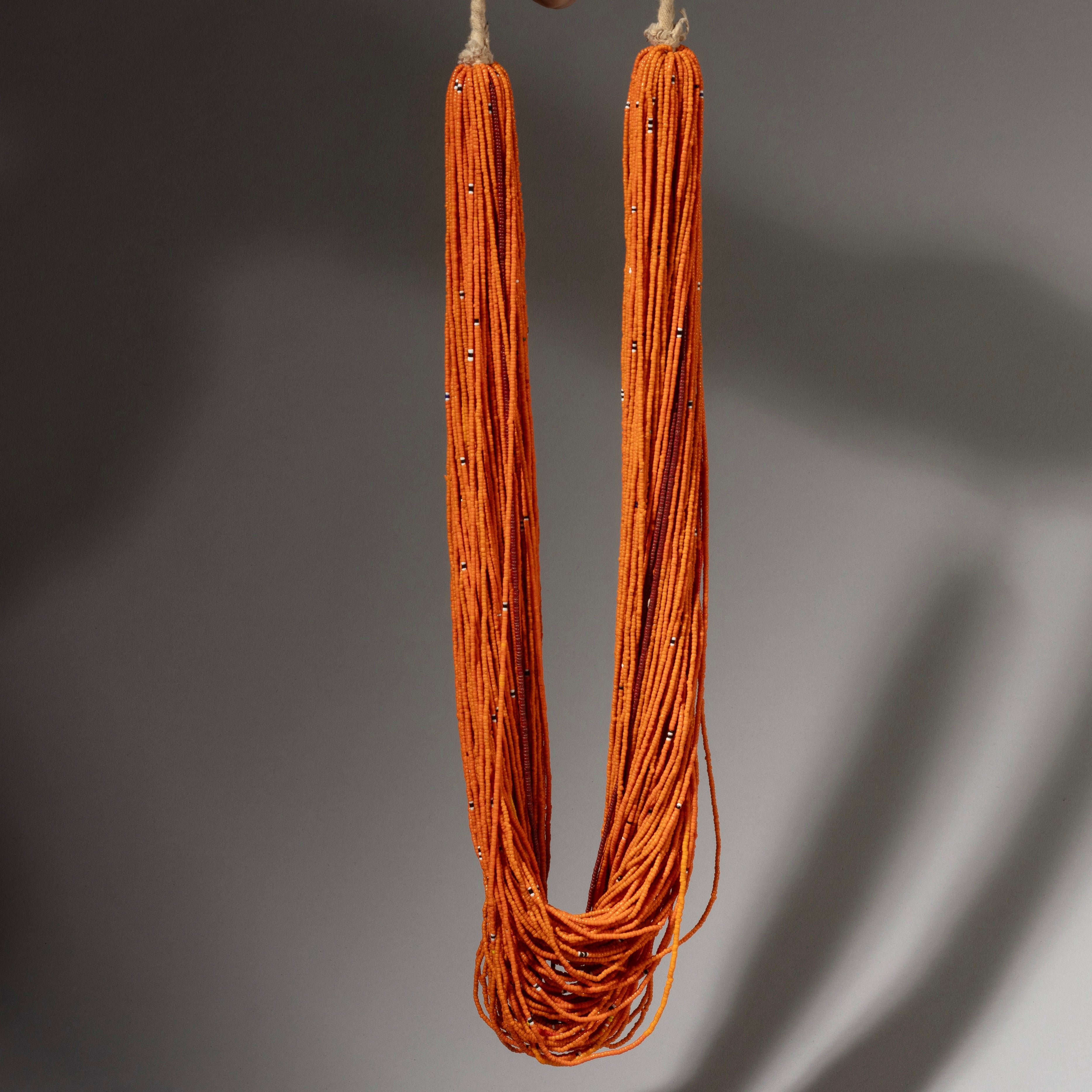 AN ORANGE  MULTISTRAND GLASS NECKLACE, BAULE TRIBE IVORY COAST ( No 2910 )