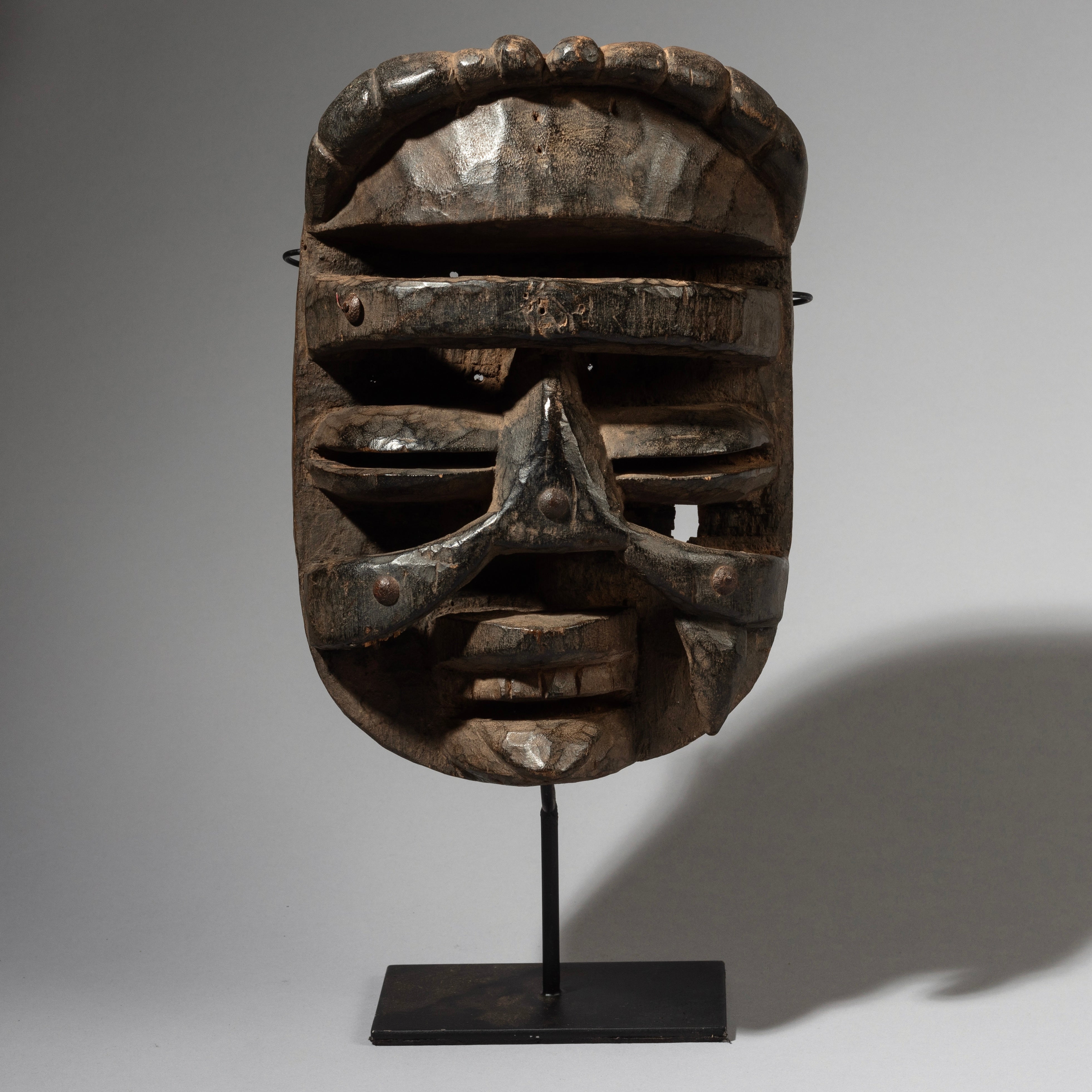 A DRAMATIC STUD ENCRUSTED BETE TRIBE MASK FROM IVORY COAST ( No 2921 )