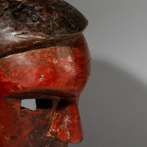 A RED SCULPTURAL + SUBSTANTIAL MASK FROM THE SUKUMA TRIBE, TANZANIA, EAST AFRICA( No 2130 )