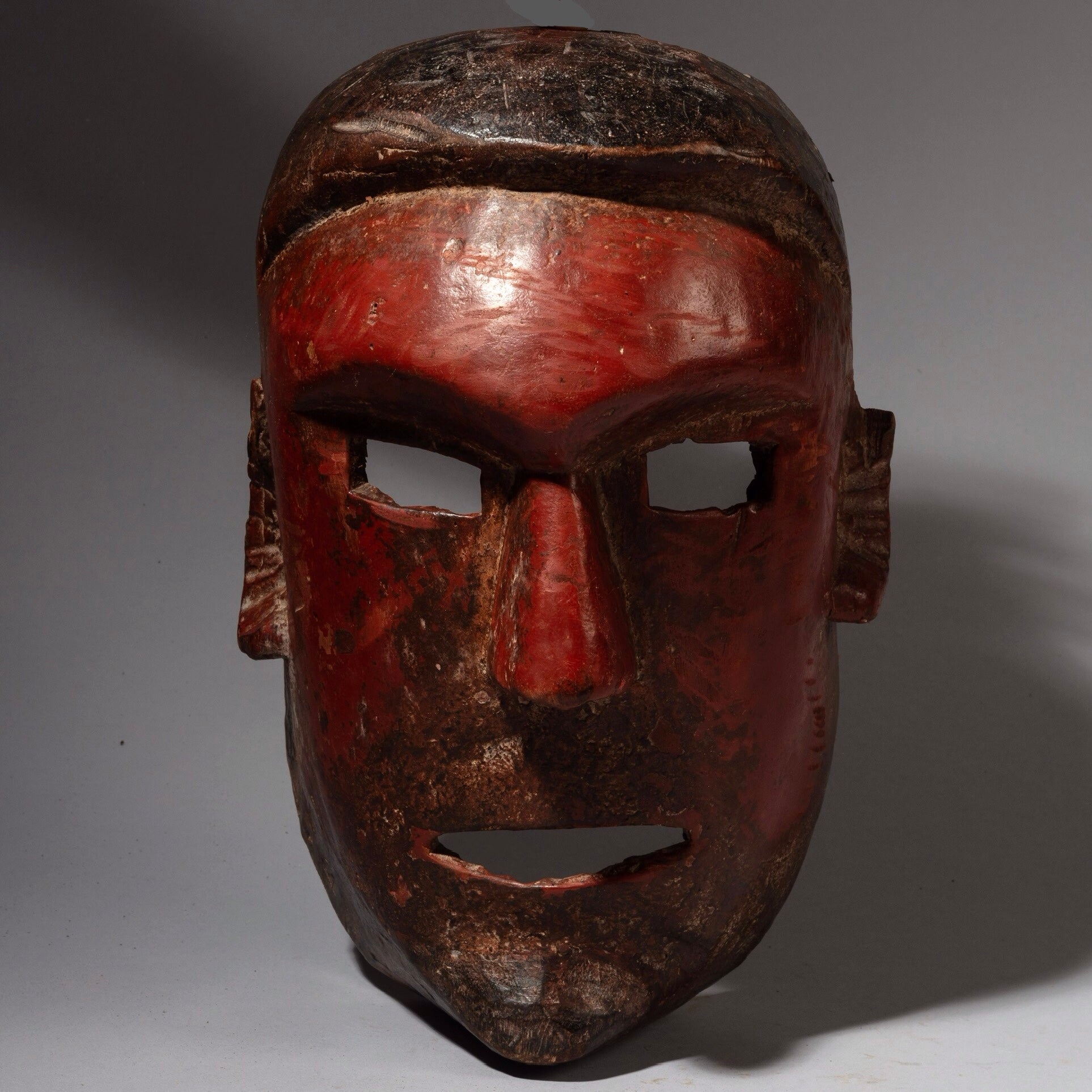 A RED SCULPTURAL + SUBSTANTIAL MASK FROM THE SUKUMA TRIBE, TANZANIA, EAST AFRICA( No 2130 )