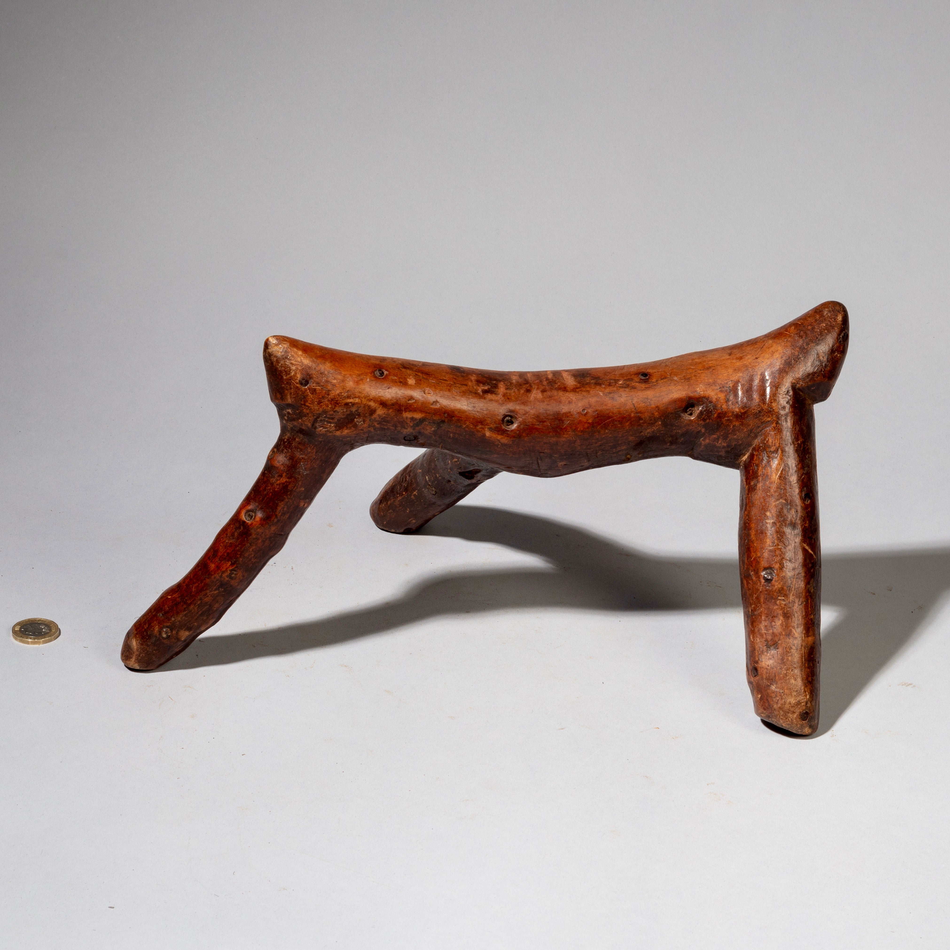 A WARMLY PATINATED 3 LEGGED HEADREST FROM KENYA ( No 2226)