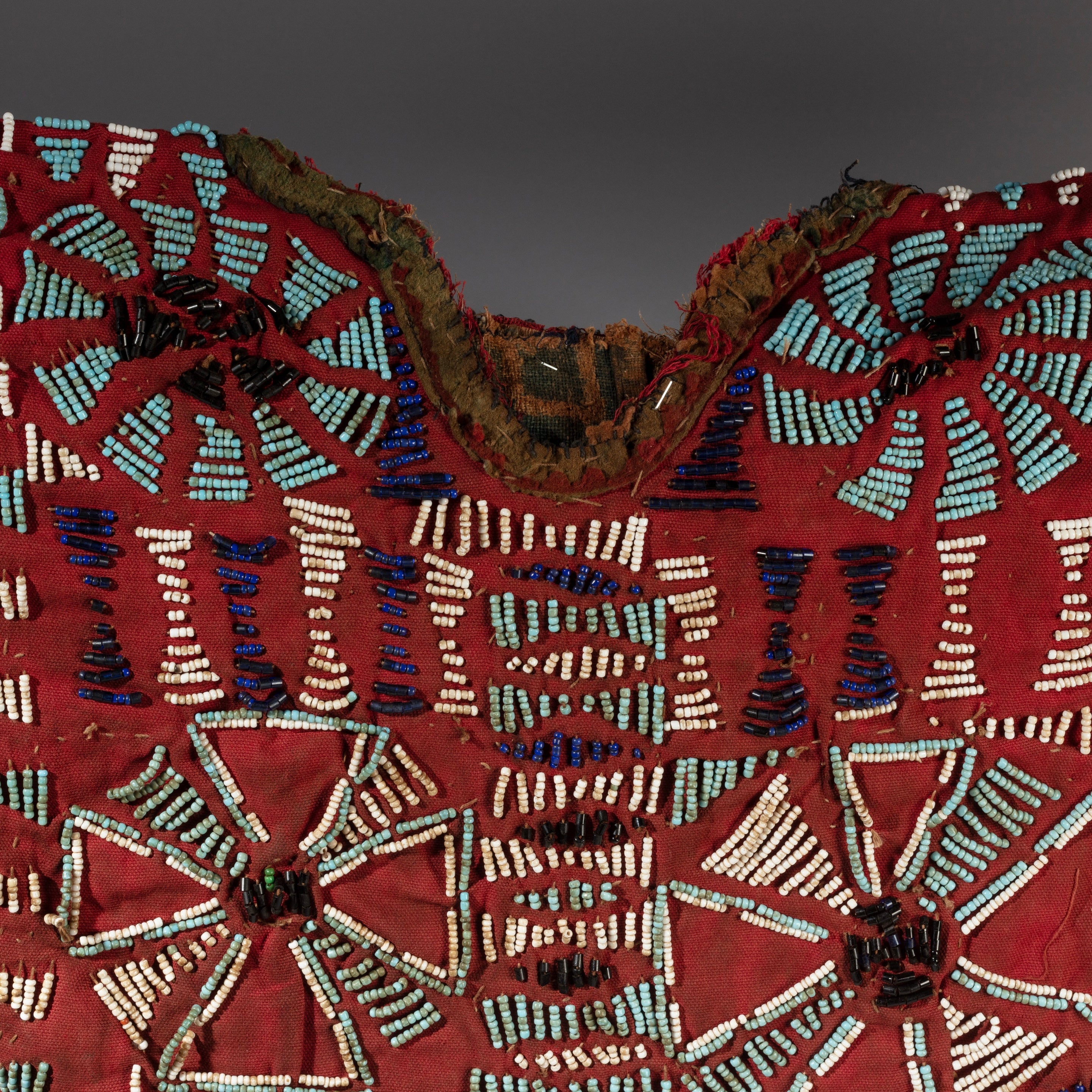 AN ARTISTIC DOUBLE SIDED RED BEADED SHIRT WITH NDOP TRIM, BAMILEKE TRIBE OF CAMEROON ( No 4100 )