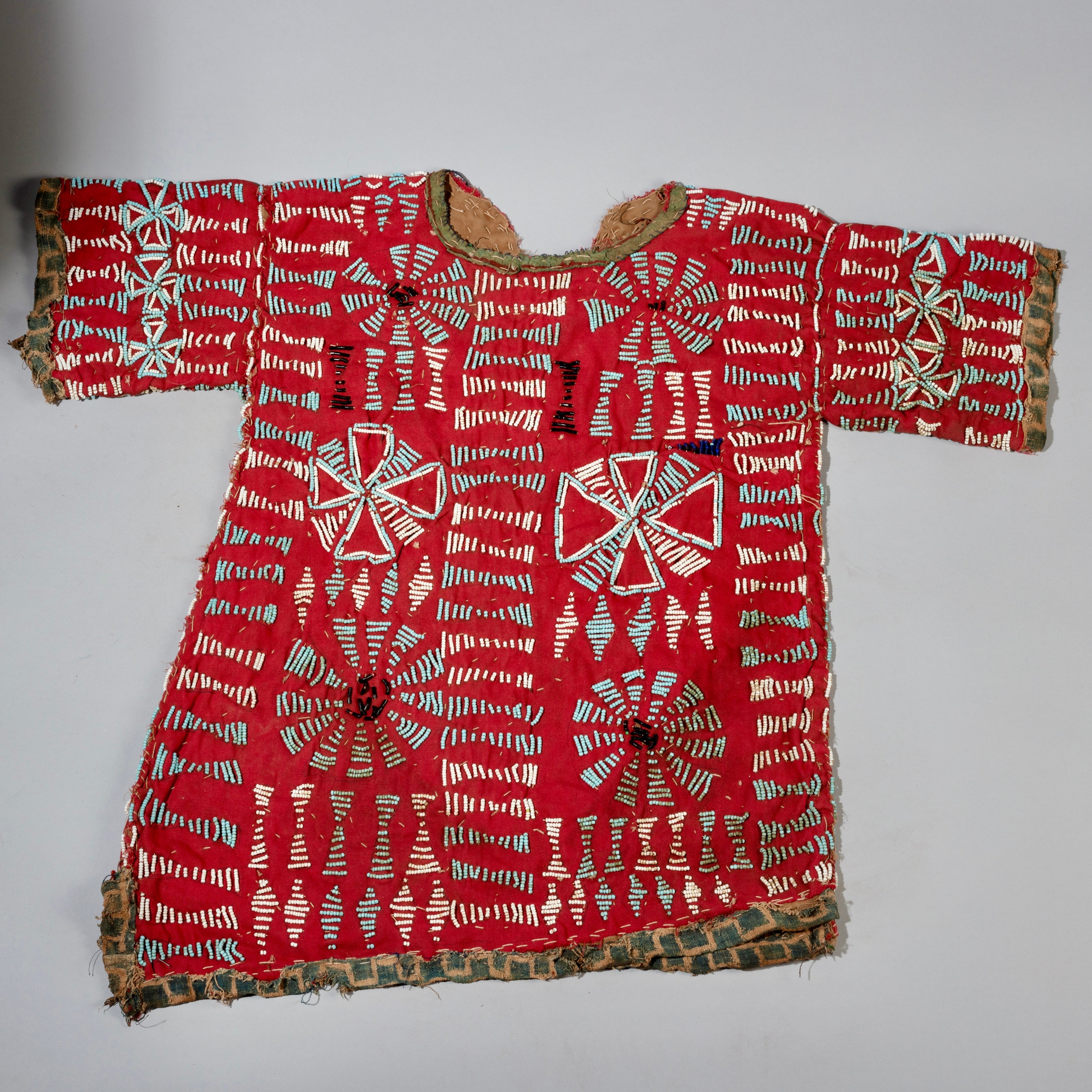 AN ARTISTIC DOUBLE SIDED RED BEADED SHIRT WITH NDOP TRIM, BAMILEKE TRIBE OF CAMEROON ( No 4100 )