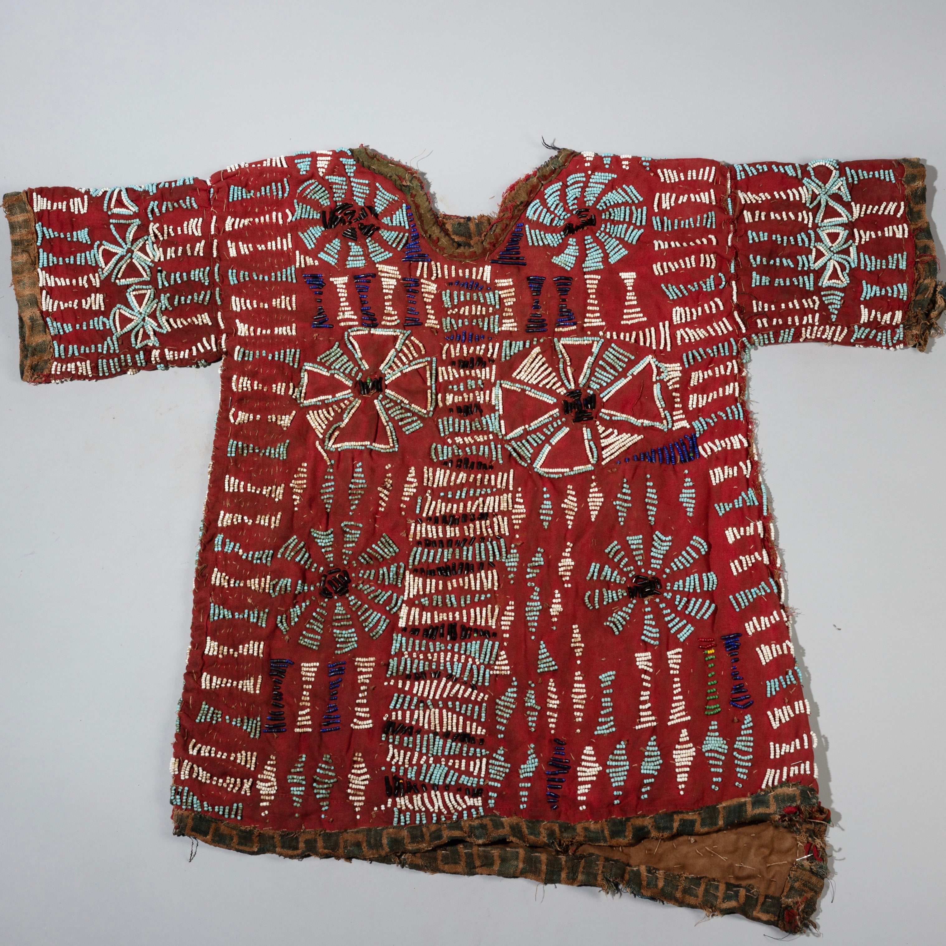 AN ARTISTIC DOUBLE SIDED RED BEADED SHIRT WITH NDOP TRIM, BAMILEKE TRIBE OF CAMEROON ( No 4100 )