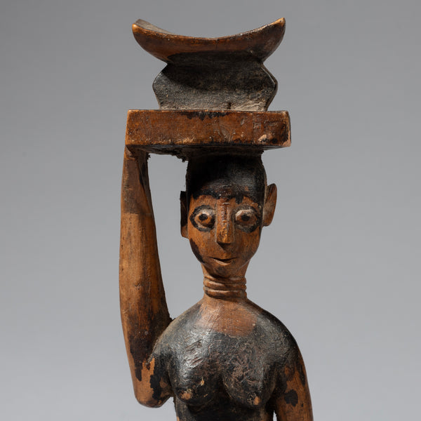 A ROMANTIC ALTAR FIGURE HOLDING A STOOL FROM THE BAULE TRIBE OF IVORY COAST , WEST AFRICA( No 2332)