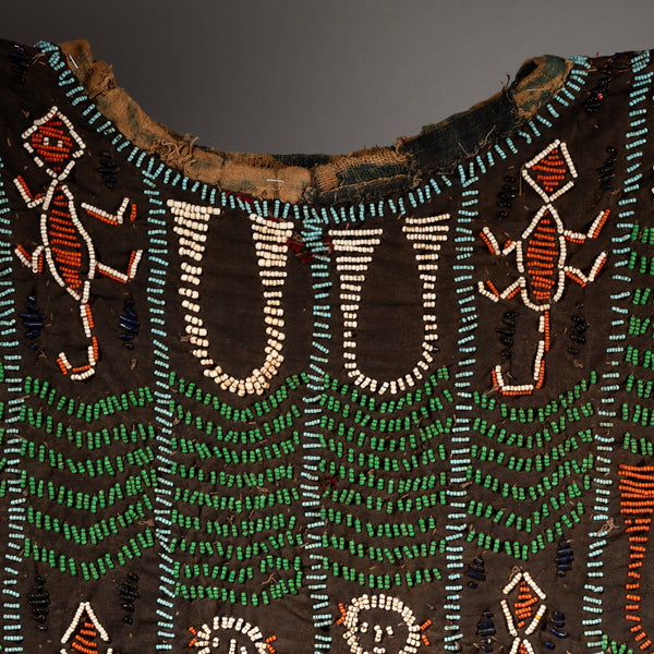 AN ARTISTIC BEADED SHIRT WITH NDOP TRIM, BAMILEKE TRIBE OF CAMEROON ( No 2338)