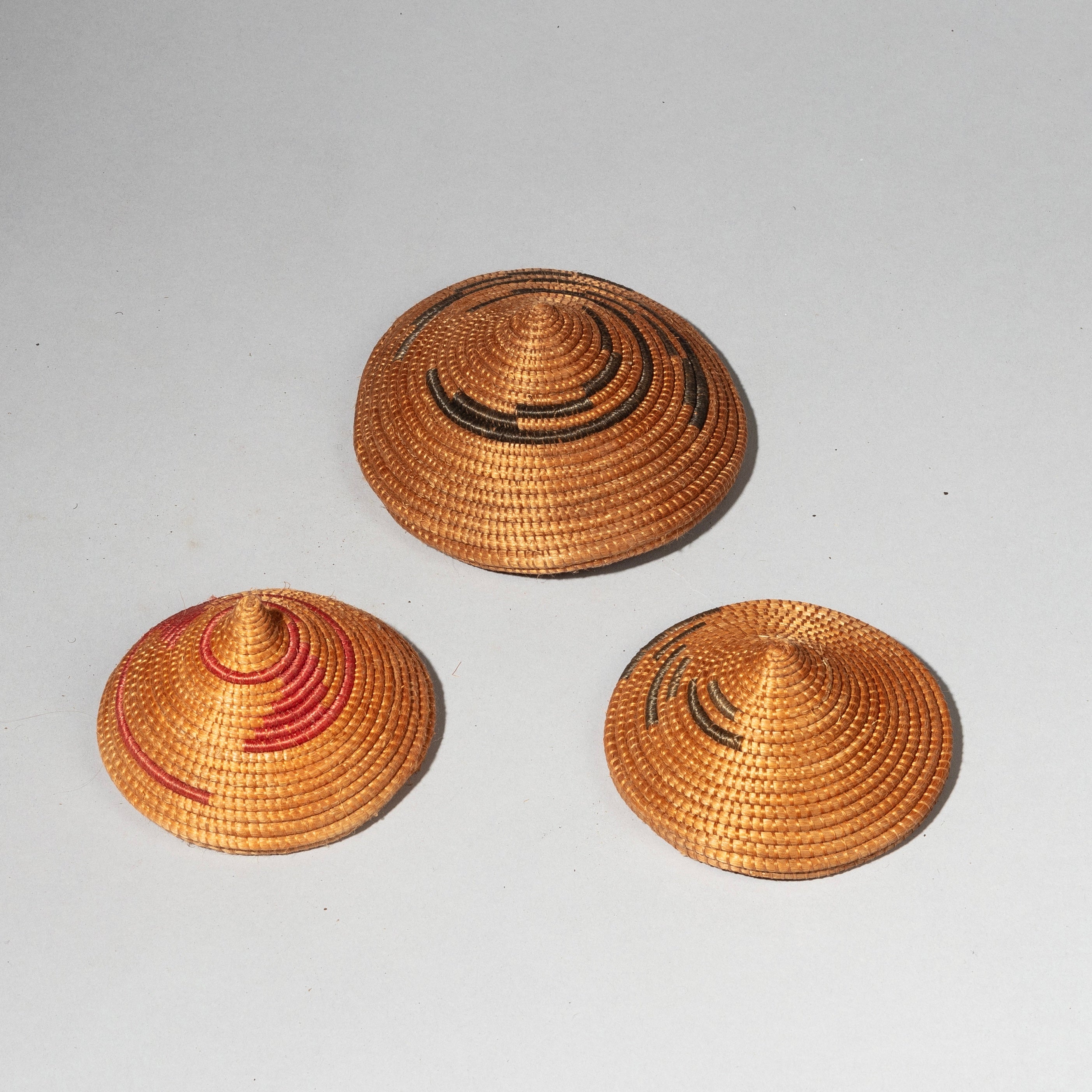 A CLUSTER OF WOVEN LIDS, TUTSI TRIBE RWANDA ( No 2409)