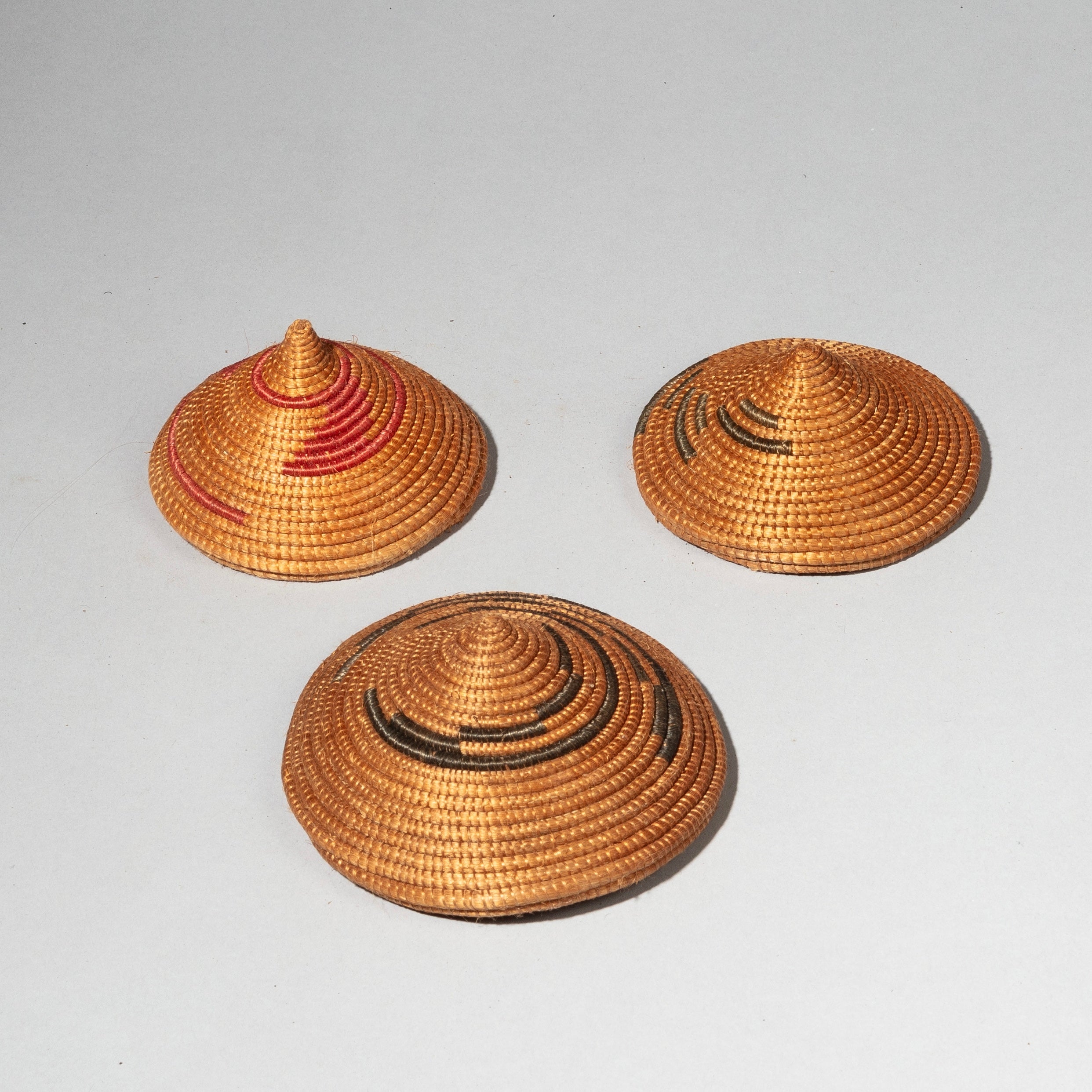 A CLUSTER OF WOVEN LIDS, TUTSI TRIBE RWANDA ( No 2409)