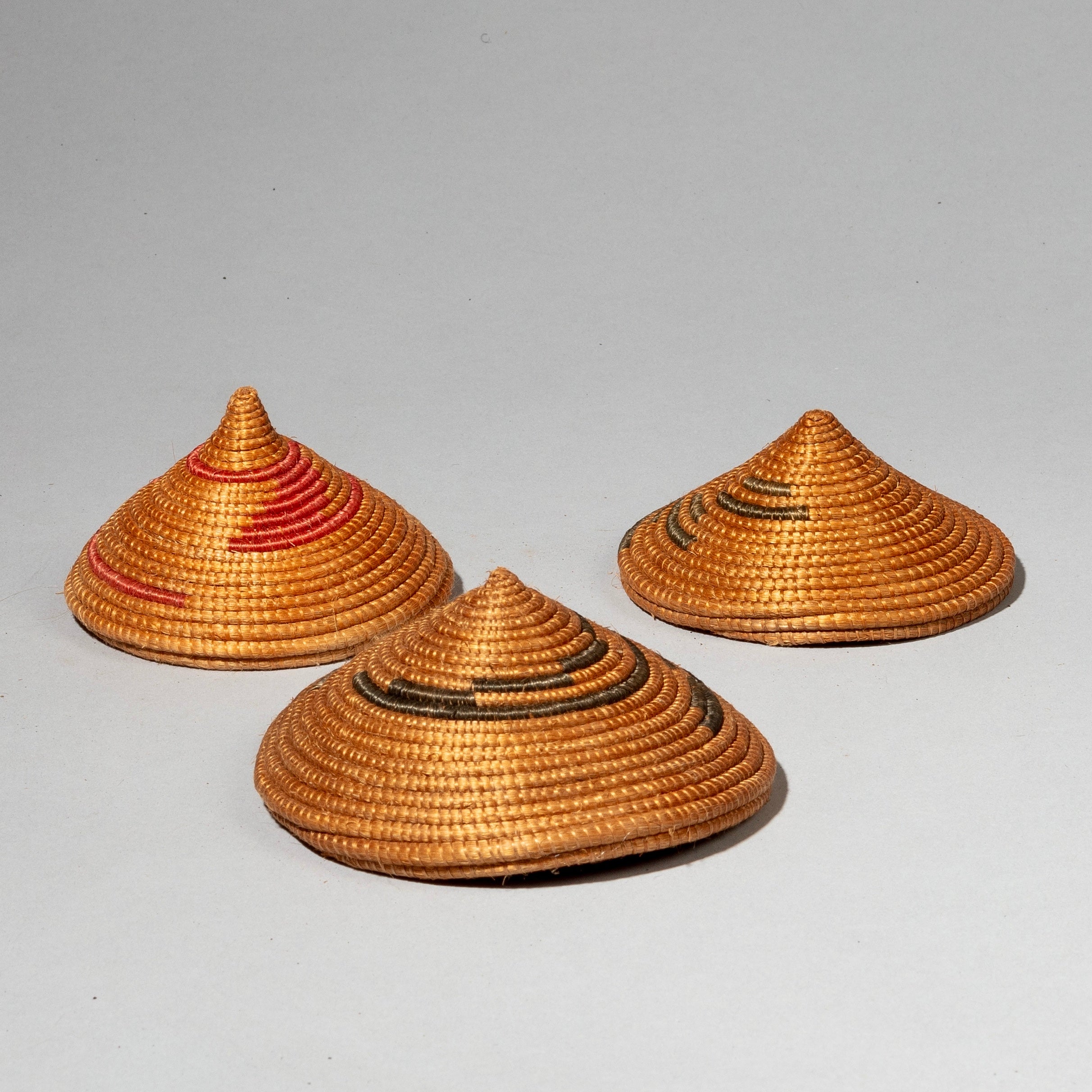 A CLUSTER OF WOVEN LIDS, TUTSI TRIBE RWANDA ( No 2409)