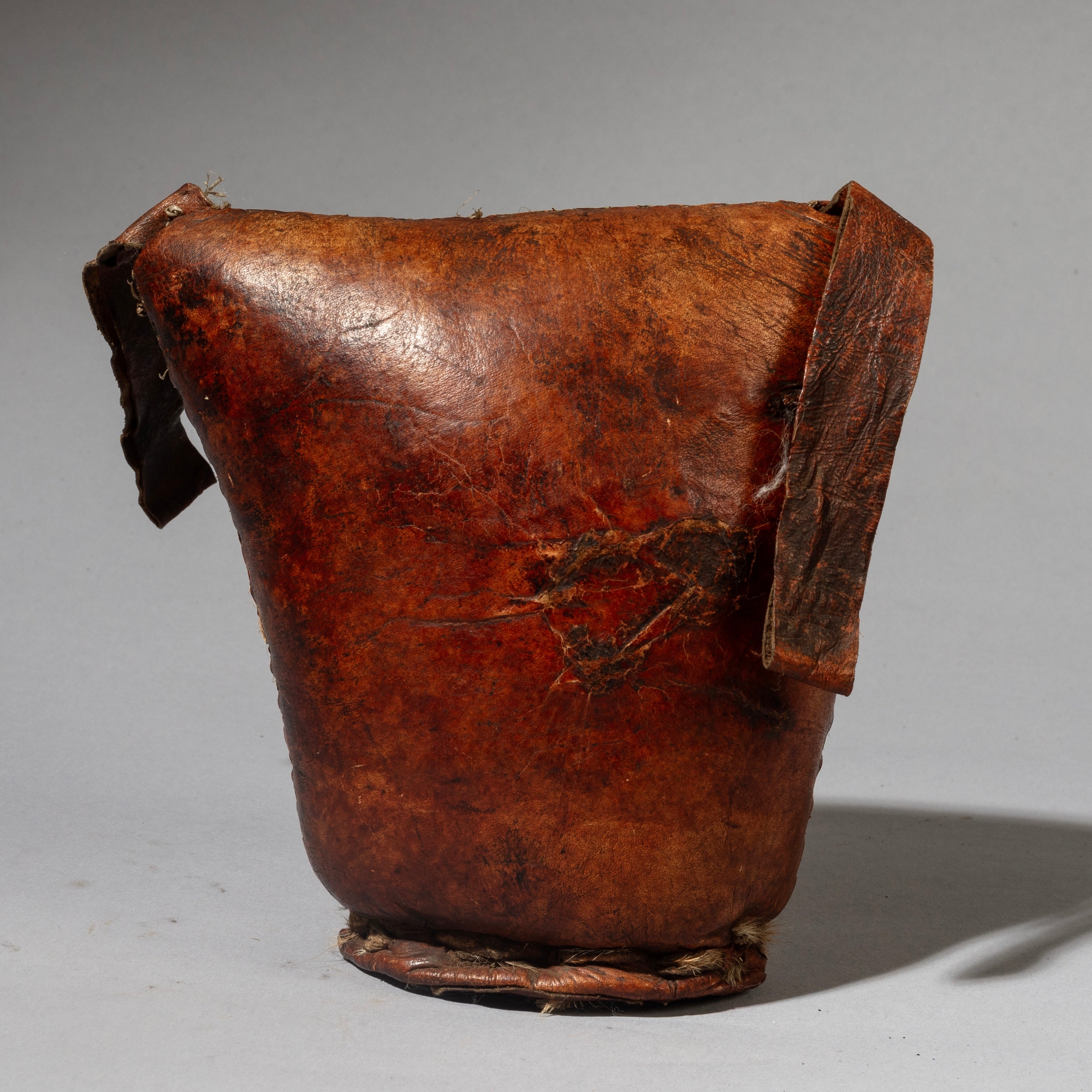 A WARMLY PATINATED ETHIOPIAN LEATHER HEADREST, WELL USED, GURAGE TRIBE, E AFRICA EX UK COLLECTION ( No 4518)