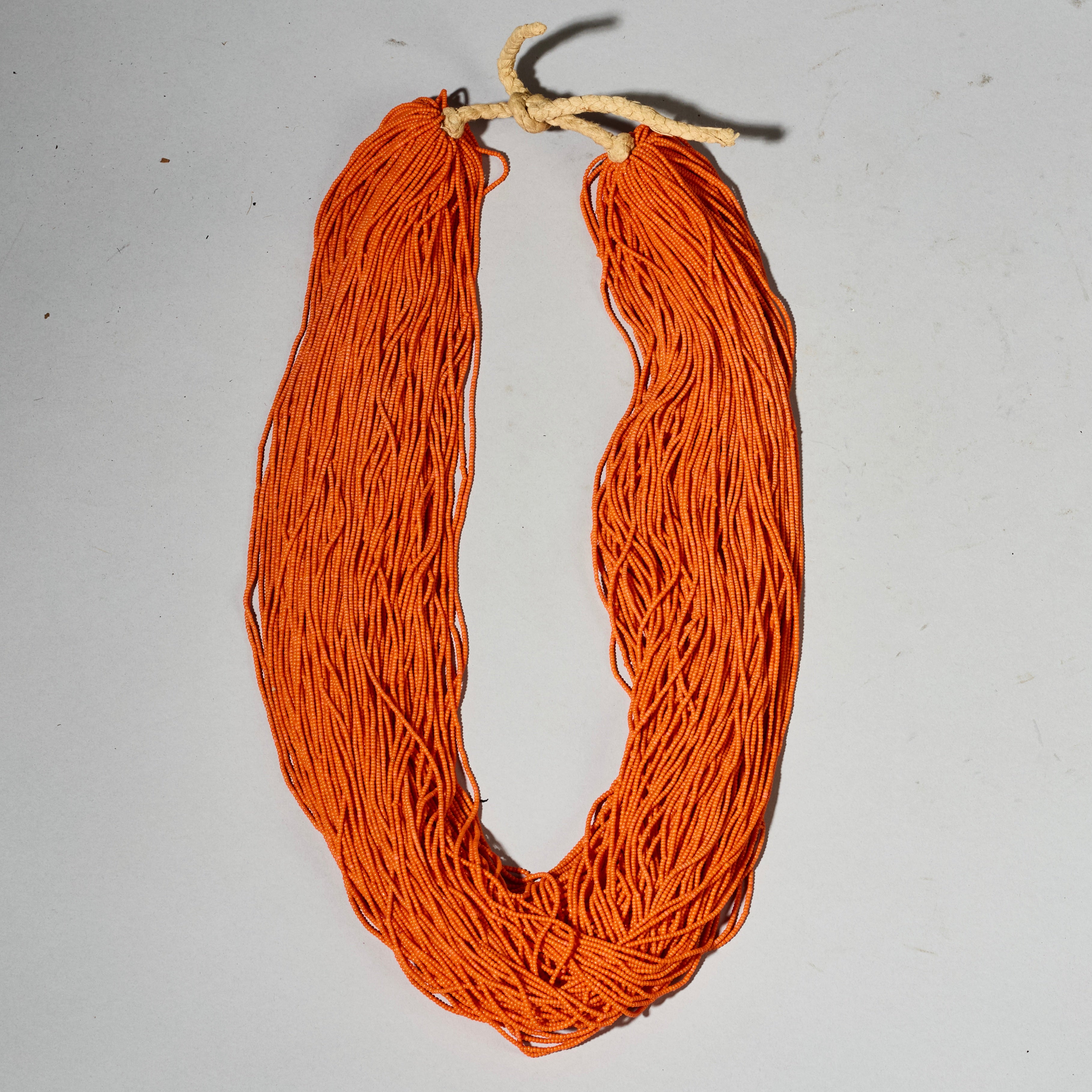 AN ORANGE MULTISTRAND NECKLACE,  BAULE TRIBE IVORY COAST ( No 4926