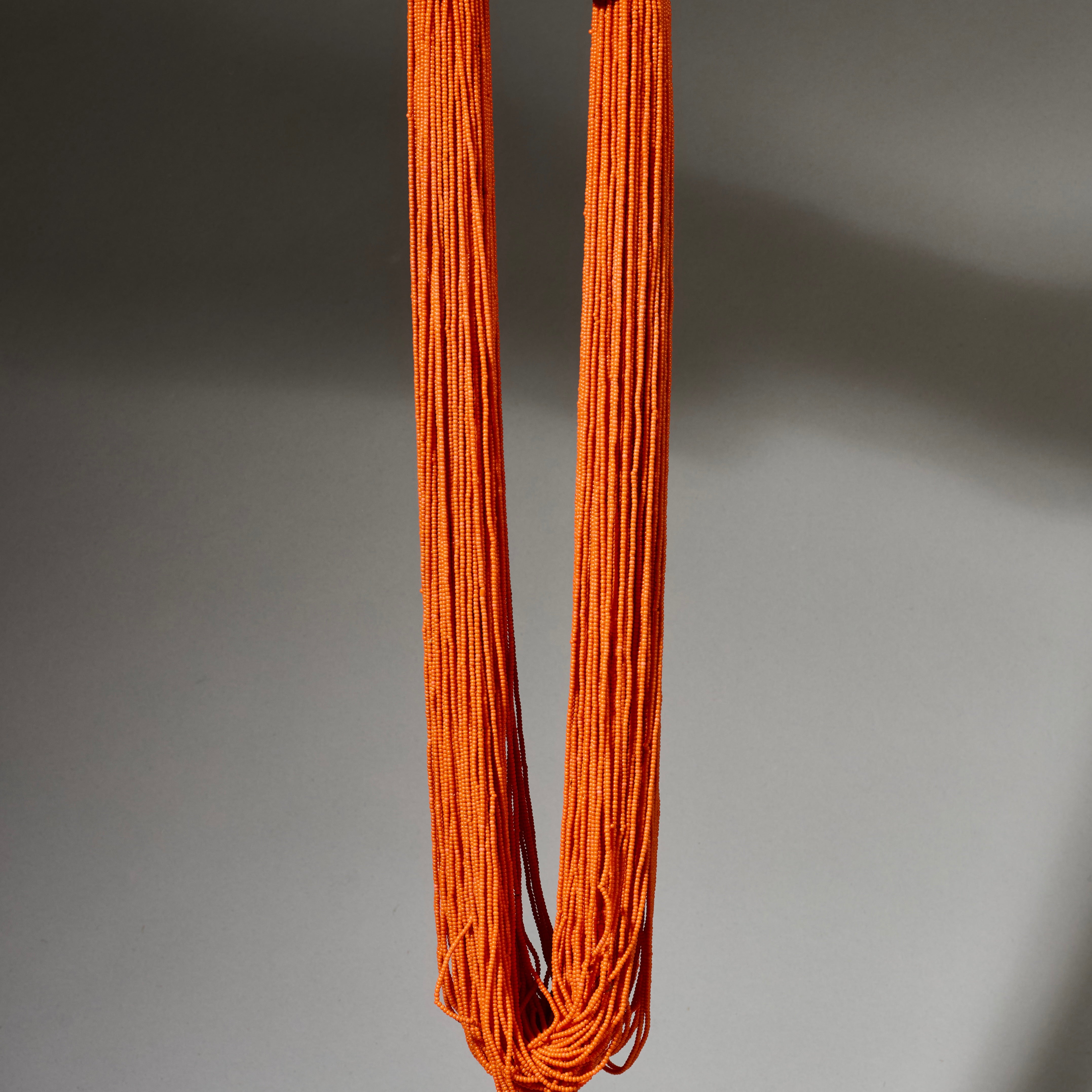 AN ORANGE MULTISTRAND NECKLACE,  BAULE TRIBE IVORY COAST ( No 4926