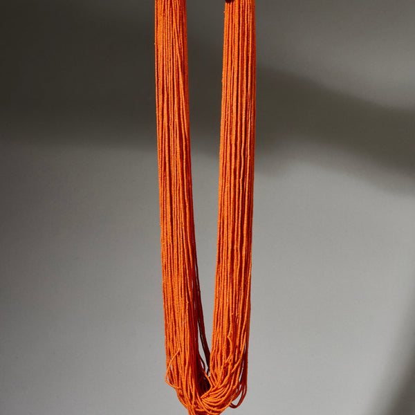 AN ORANGE MULTISTRAND NECKLACE,  BAULE TRIBE IVORY COAST ( No 4926