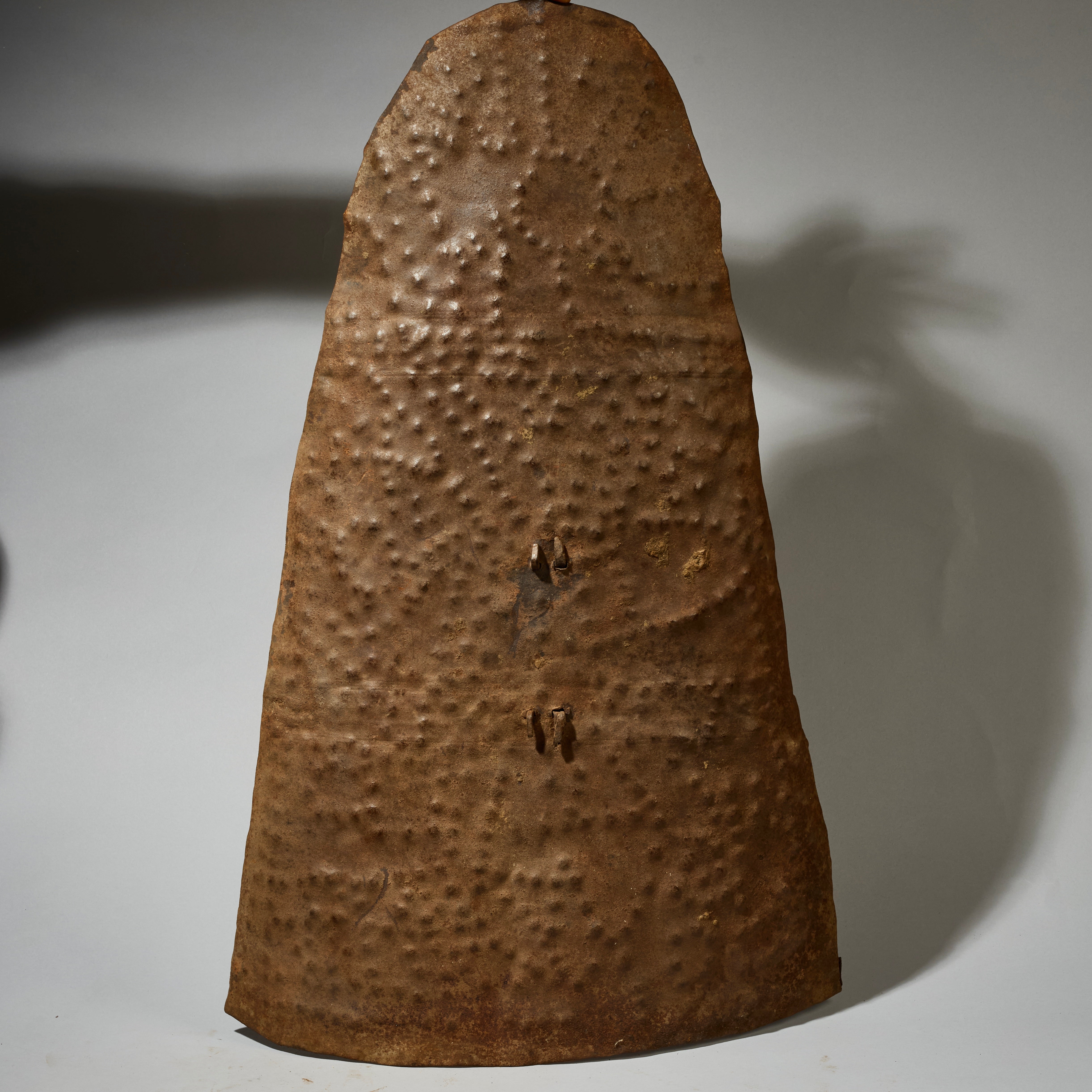 AN EMBOSSED, BELL SHAPED SHIELD, KIRDI TRIBE N CAMEROON, W.AFRICA WITH GOOD AGE AND PATINA  ( No 5074)