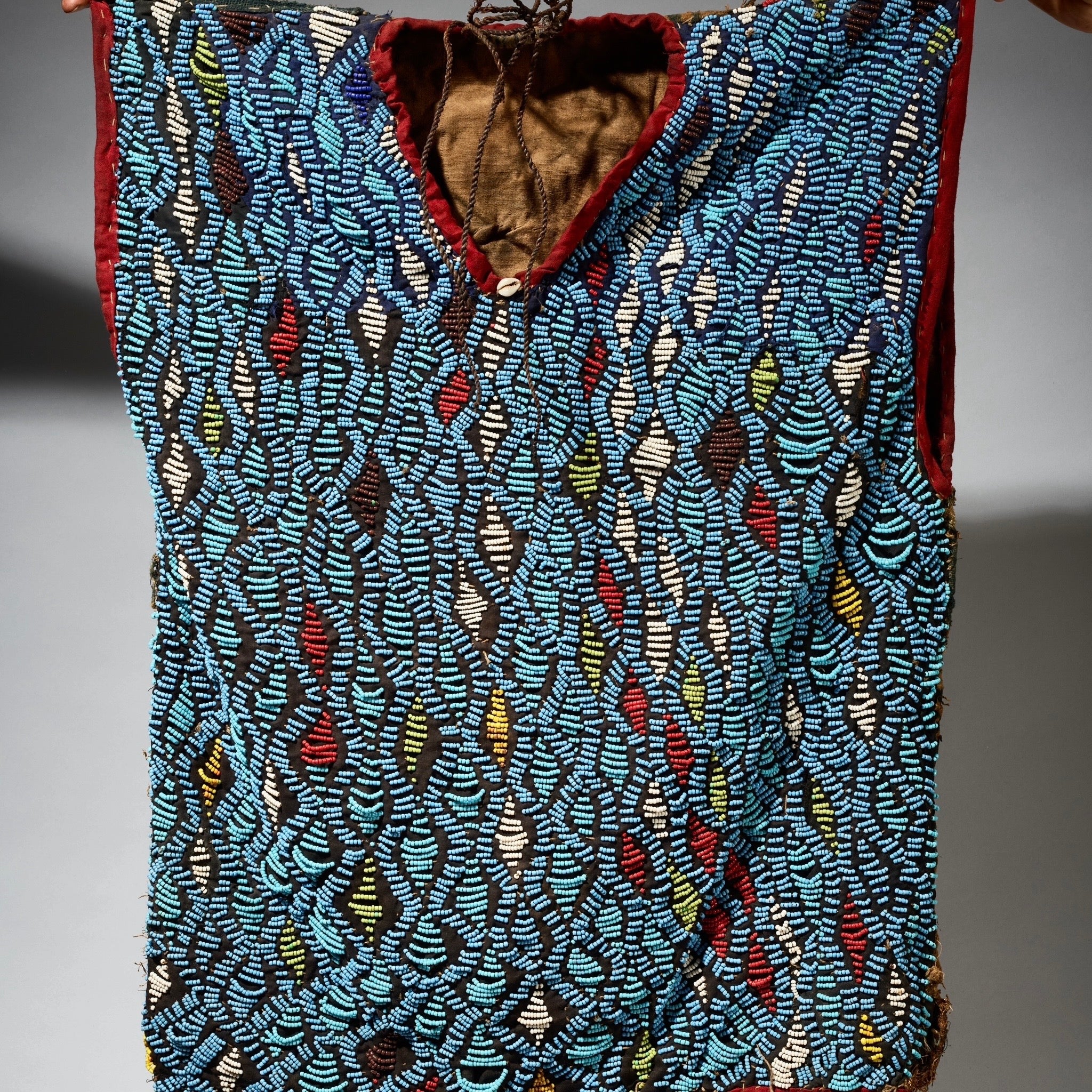 AN ARTISTIC BEADED SHIRT WITH NDOP TRIM, BAMILEKE TRIBE OF CAMEROON ( No 5113 )