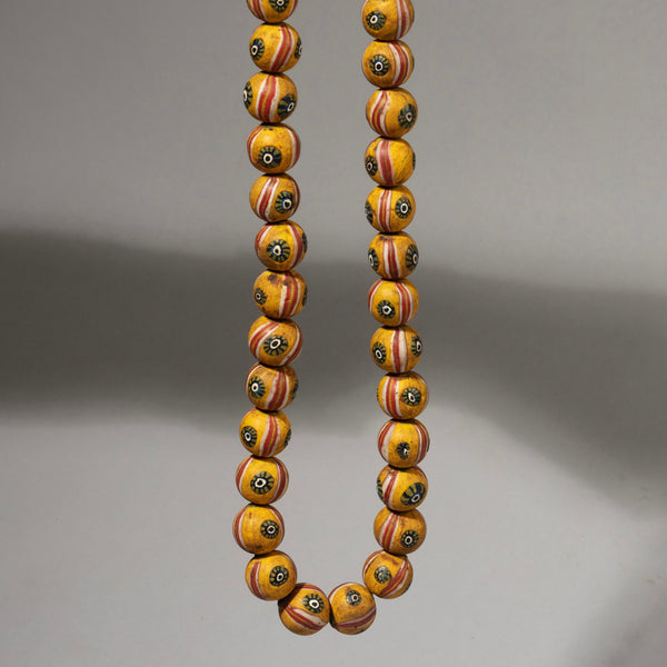 A BUTTERCUP YELOW SOLID GLASS NECKLACE FROM JAVA ( No 1058)