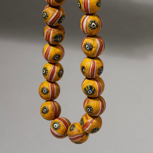 A BUTTERCUP YELOW SOLID GLASS NECKLACE FROM JAVA ( No 1058)